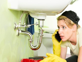 woman-calling-rooter-professionals-for-leaky-kitchen-sink-2vvij2e77zwym2z03to6iy